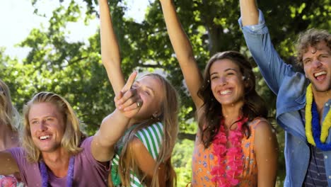 Animation-of-white-spots-falling-over-happy-people-dancing-outdoors