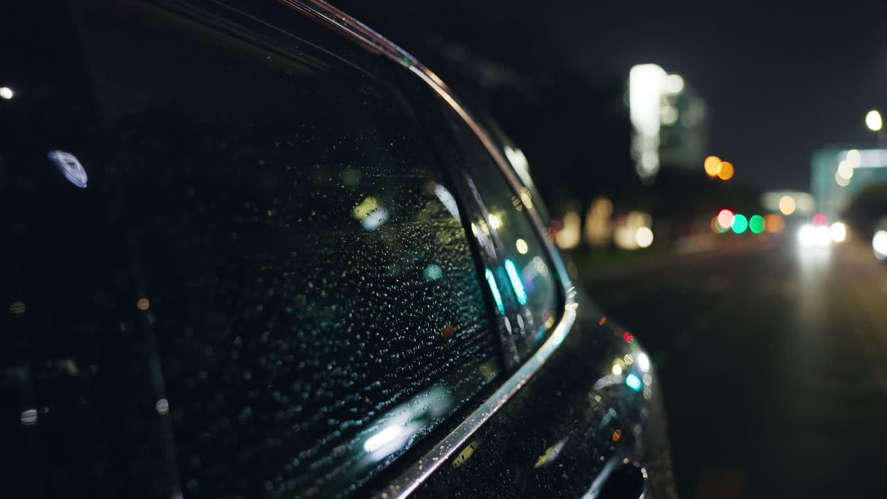 Car in the city at night with rain