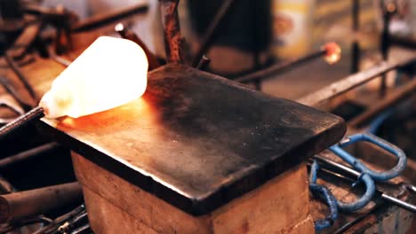 glassblower shaping a molten glass