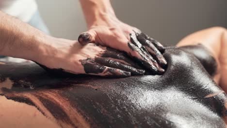 closeup, male hands massaging back of chocolate with male