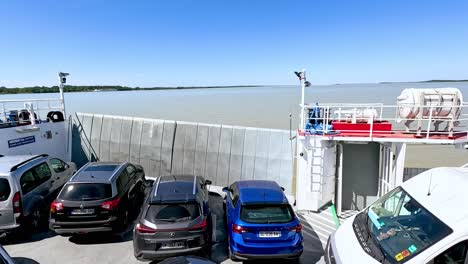 vehicles parked on a ferry crossing water