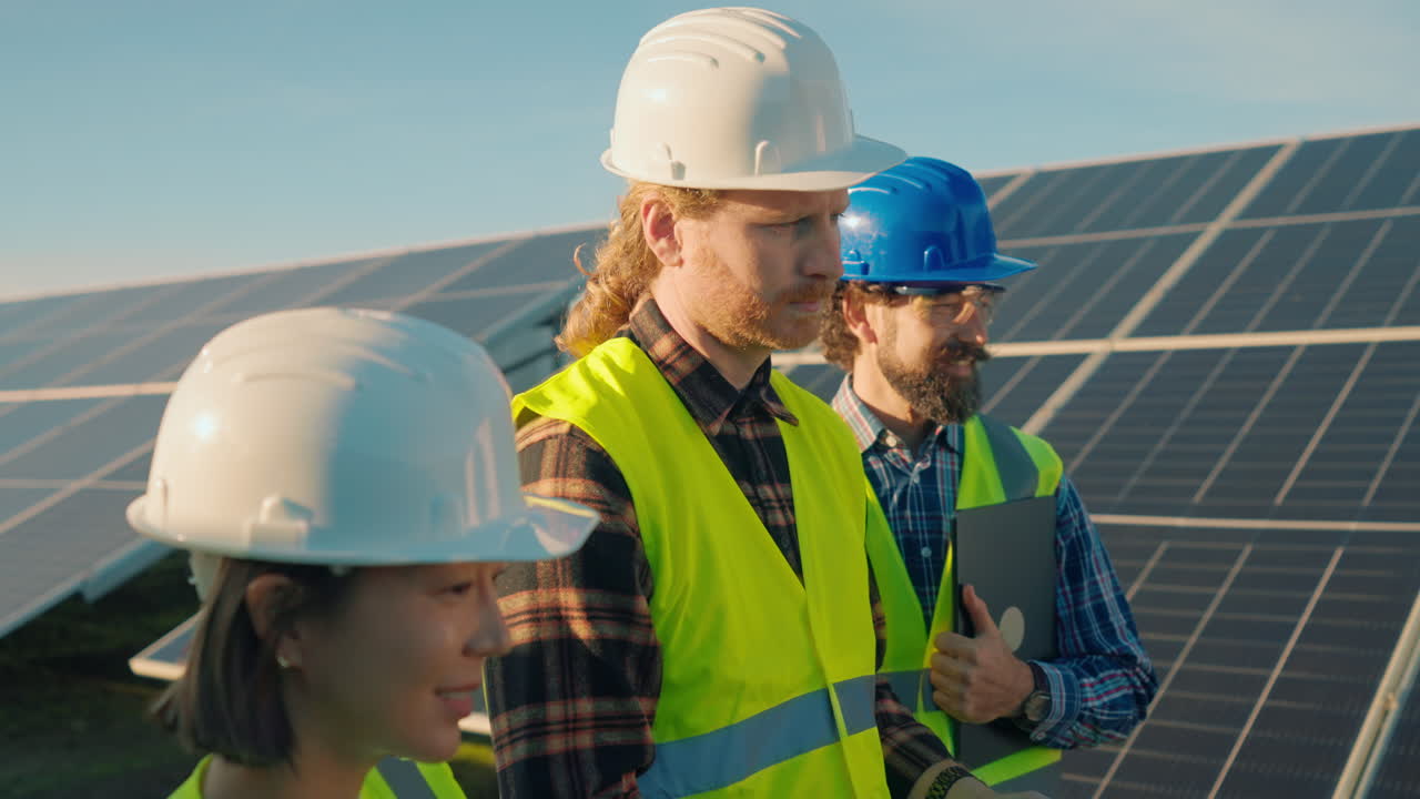 Construction workers inspecting solar panels with drone