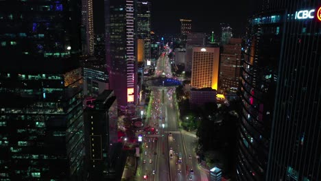 night time illuminated jakarta city center traffic street circle fountain aerial panorama 4k indonesia