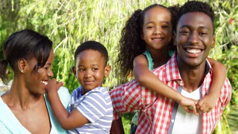 a family having hug together, each parent holding a child