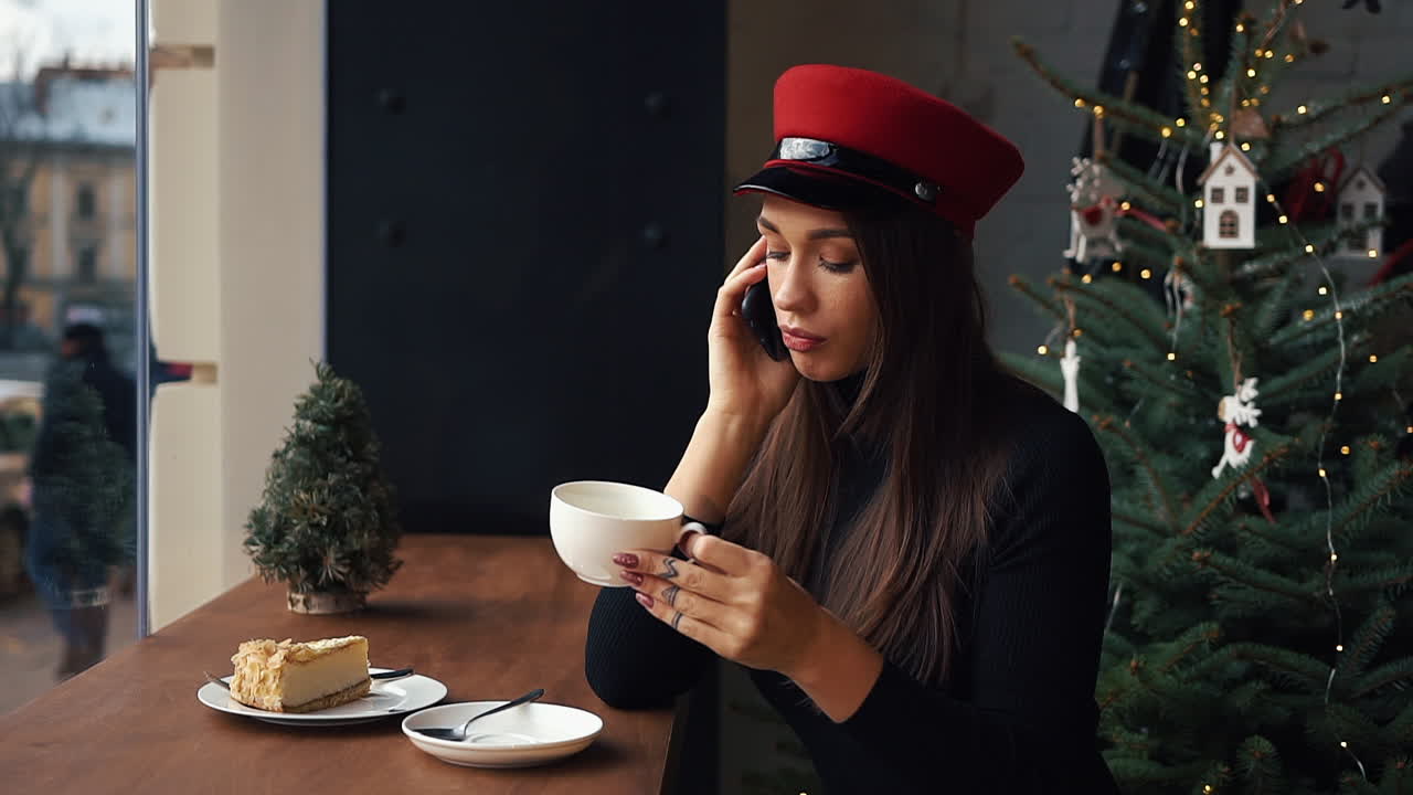 Woman enjoying coffee and cake in a cafe during the Christmas season