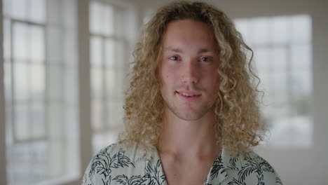 portrait of handsome young man smiling confident looking at camera enjoying independent student lifestyle in new apartment