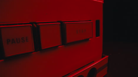 a close-up on a vintage tape recorder in a red blinking light