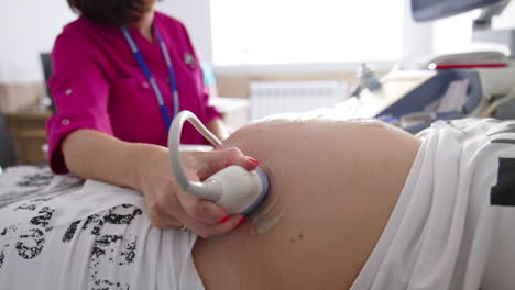 pregnant woman getting ultrasound screening. modern ultrasound examination during pregnancy.