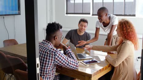 Front-view-of-young-mixed-race-business-team-planning-and-sitting-in-meeting-room-in-office-4k