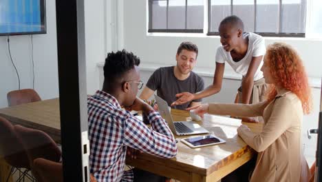 front view of young mixed-race business team planning and sitting in meeting room in office 4k