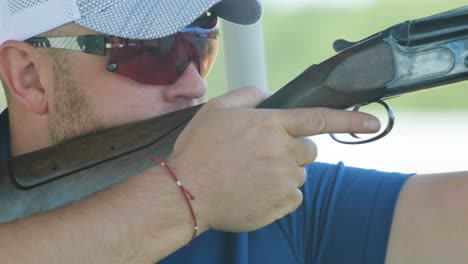 sportsman shoots from a double-barreled shotgun, a sports field for a shooting test is shooting at flying skeet