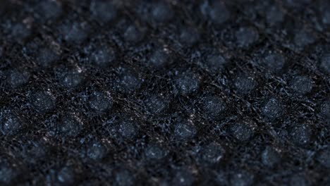 black textile cloth surface texture, macro shot close up view with rotation motion