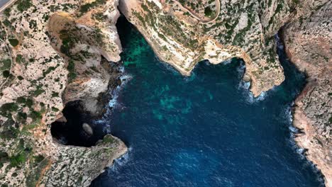 top down drone view of blue grotto and malta coastline