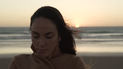 tender woman on seashore on windy day