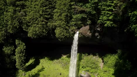 slow motion of water cascade in straight plunge down through steep basaltic bedrock in summer