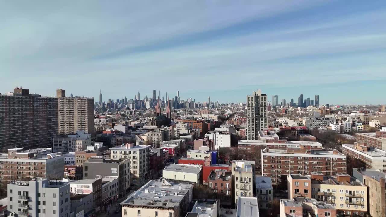 Horizontal drone ascending shot over Varet Street in Brooklyn, showcasing New York’s urban streets, historic buildings, and city skyline as the camera smoothly rises.