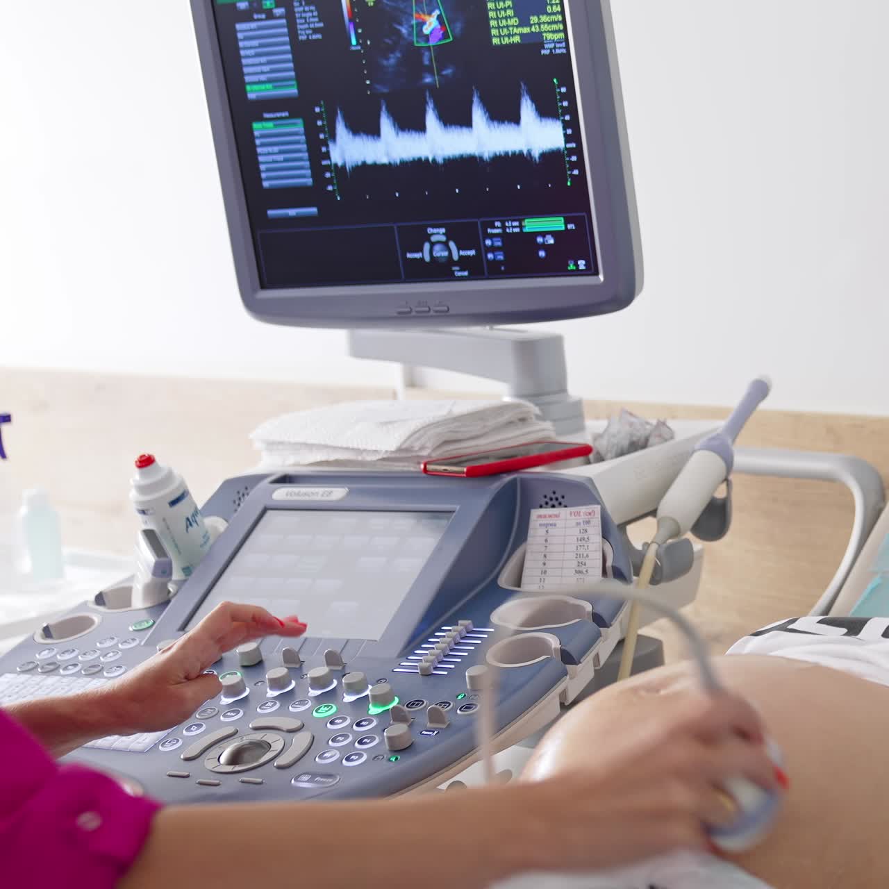 Pregnant Woman Having 4D Ultrasound Scan. Pregnancy and Healthcare concept. Process of fetus ultrasonography