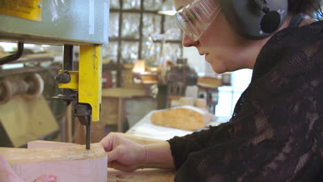 bespoke shoemaker cutting wooden last for shoe using jigsaw