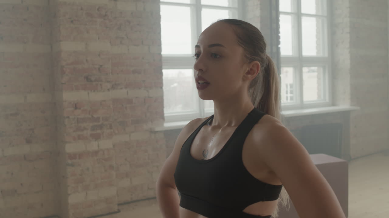 Tired Sportswoman Wiping Sweat From Forehead