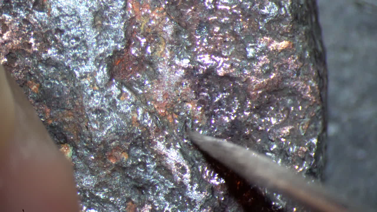 Looking through microscope cleaning coin from Ancient Rome