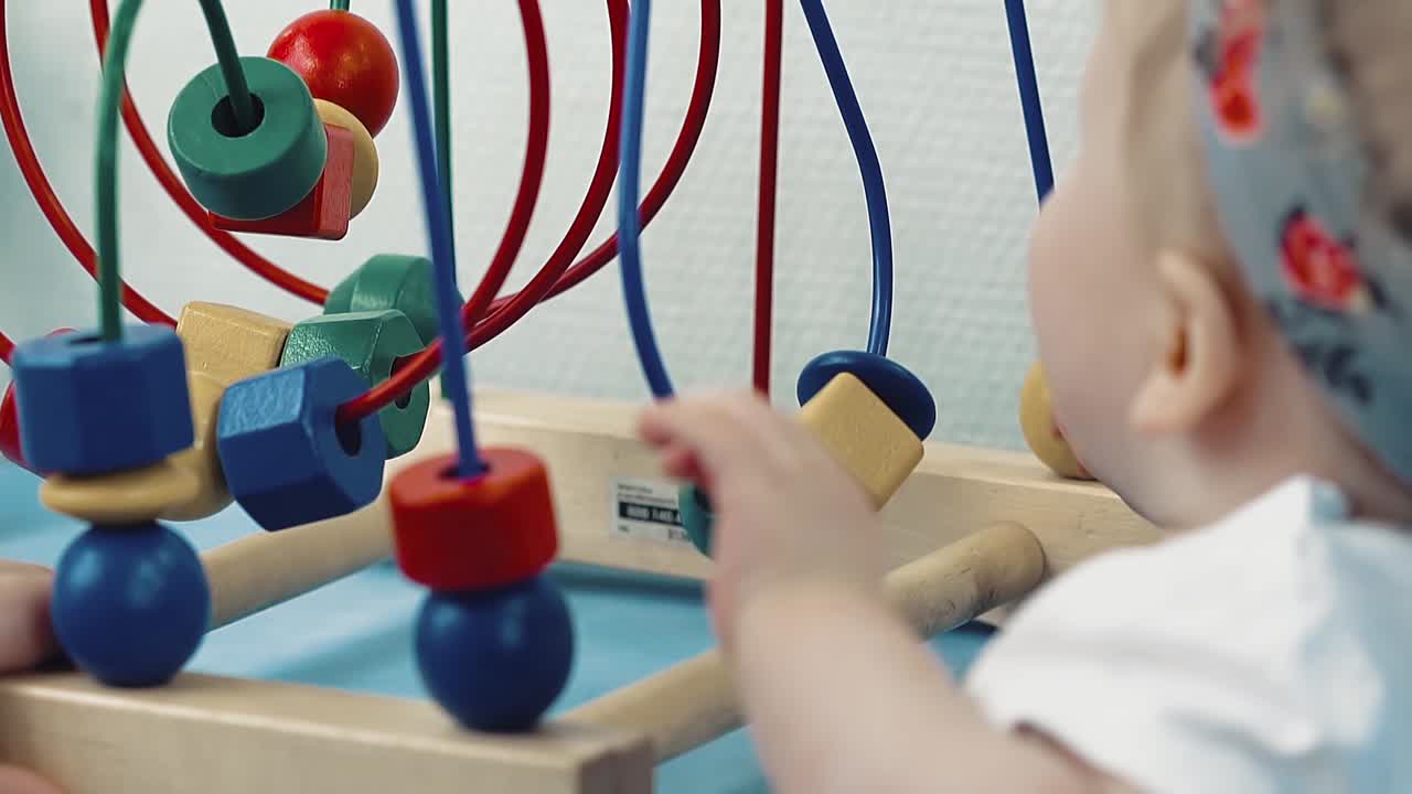 Child plays with a multi-colored toy 20