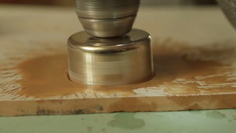 diamond crown drill a hole in a ceramic tile, close-up