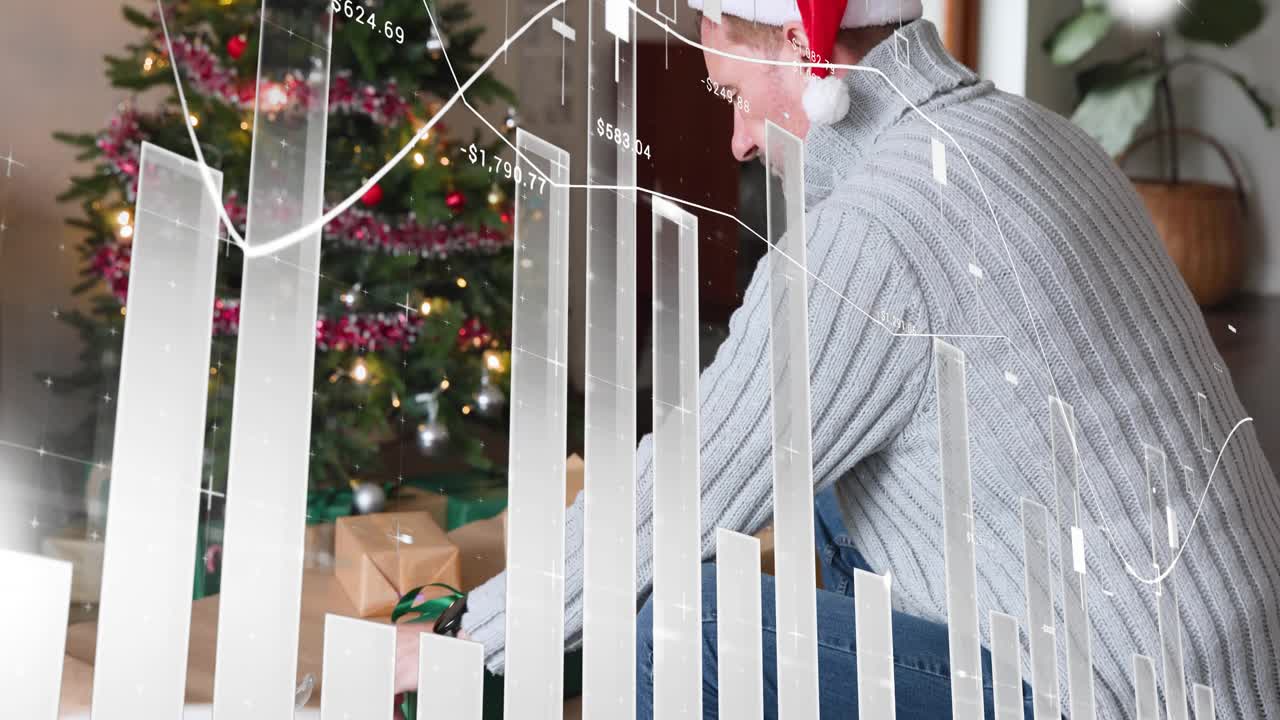 Man in Santa hat kneeling, picking gift and placing it under Xmas tree, finance graphs overlaying