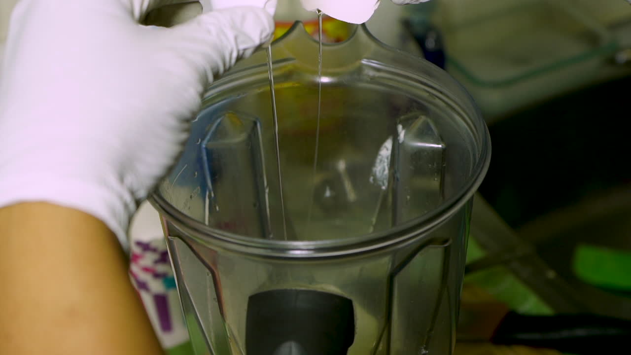 홈 베이커가 계란을 스탠드 믹서에 깨뜨리고 있습니다.