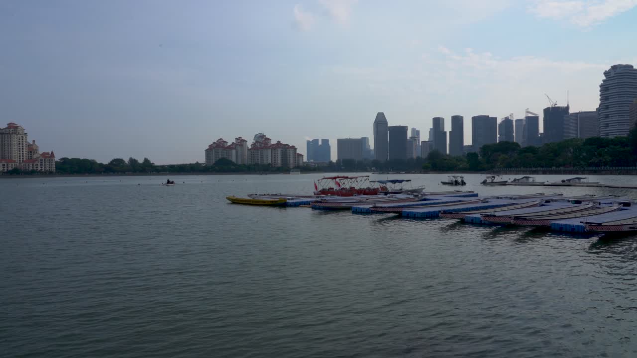 vista panorámica de la cuenca de kallang, botes de dragón en el muelle contra el paisaje urbano de singapur