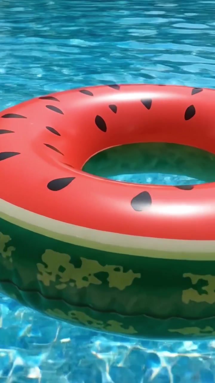 A Vibrant Summer Scene Featuring a Colorful Watermelon Pool Float Surrounded by Sparkling Crystal Clear Water in a Relaxing Swimming Pool Environment