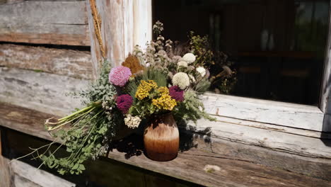 rustic floral bouquet on a wooden ledge