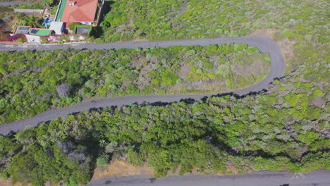 Car-driving-on-a-mountain-road-to-a-coastal-town,Tenerife,Canary-Islands,Spain