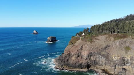 Drone-flies-over-the-ocean-toward-a-lighthouse-on-a-cliff