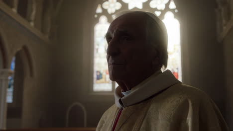 elderly religious figure in church with stained glass light