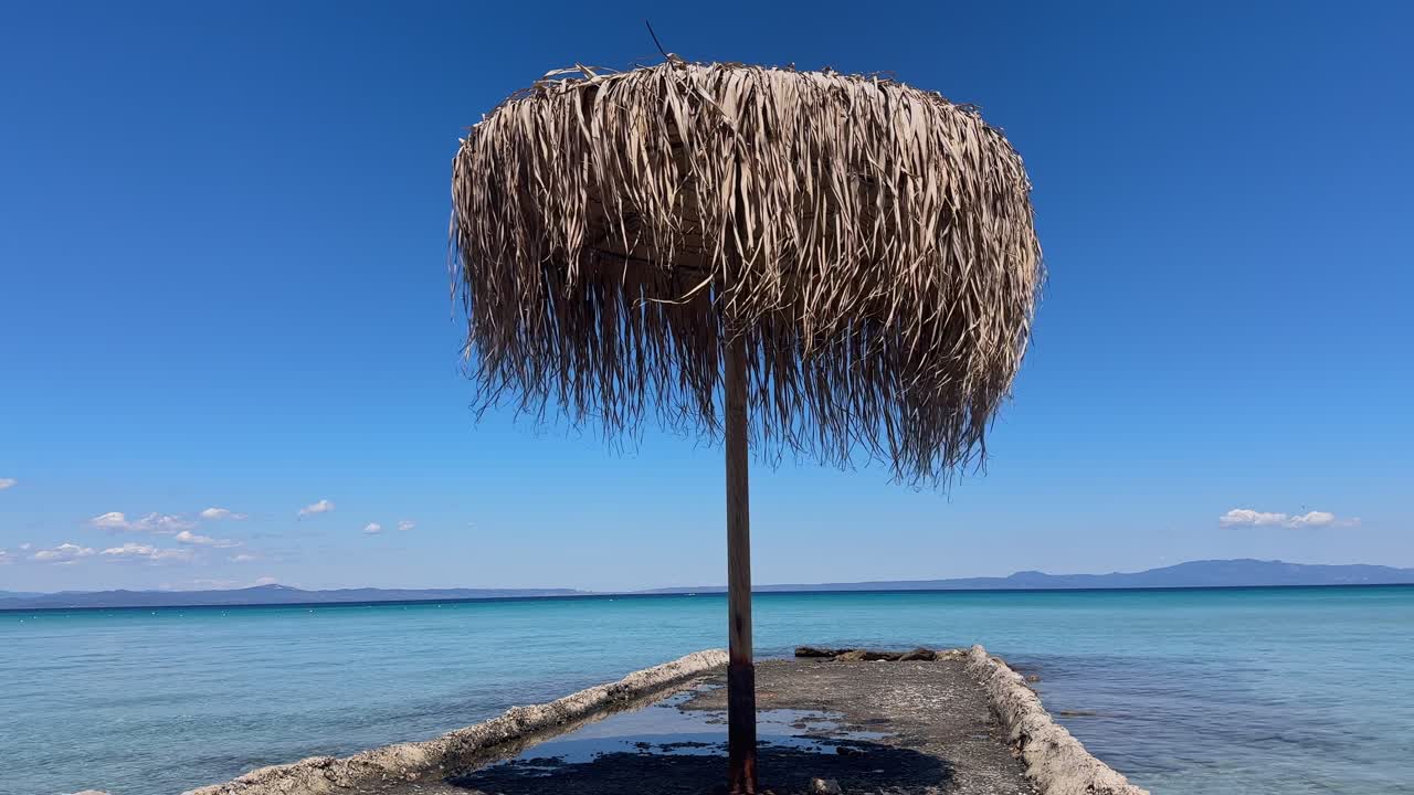 Stunning beach scene in Halkidiki, Greece, with elegant sunbeds facing the crystal-clear turquoise sea. A perfect summer escape in the heart of the Aegean.