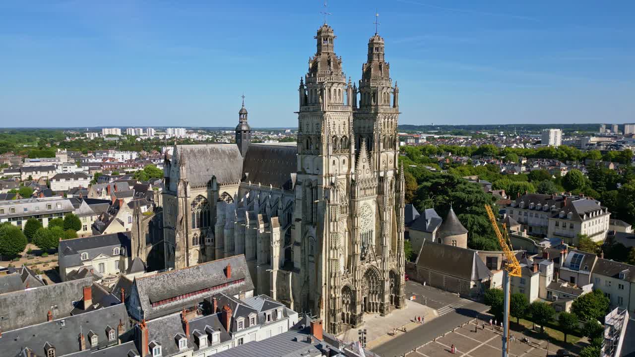 Magnificent Saint-Gatien Cathedral in Tours, gothic architecture and surrounding cityscape on sunny day, France. Aerial drone lateral view