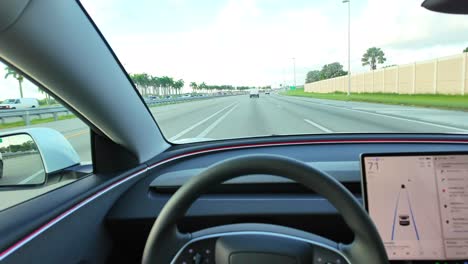 driver's pov of tesla model 3 autonomous self-steering autopilot car self driving on florida turnpike highway (route 1)