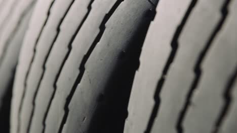 closeup dolly shot of black tires and their detailed groove stacked side ways