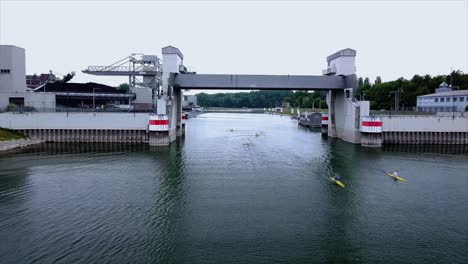 kayak and canoe paddlers on an european river filmed by a drone under hazy skies