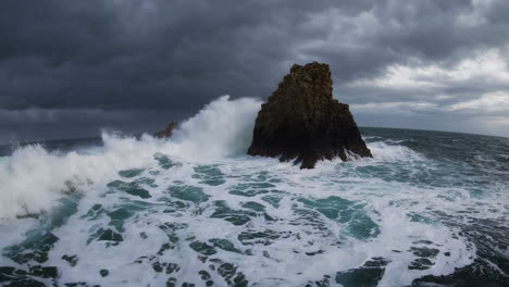 powerful waves crashing against rocky coastline during a storm