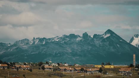 Houses-On-Tierra-del-Fuego-Coastline-With-Mountains-In-Background