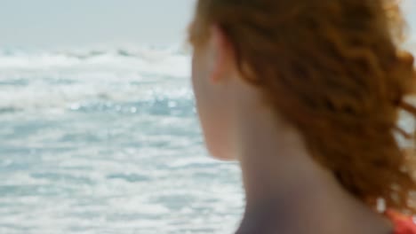 Woman-looking-at-beautiful-ocean-4k