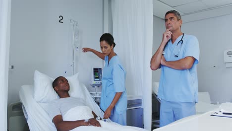 front view of caucasian male doctor using invisible screen in ward at hospital