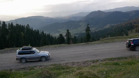 three suv ride on top of the mountains