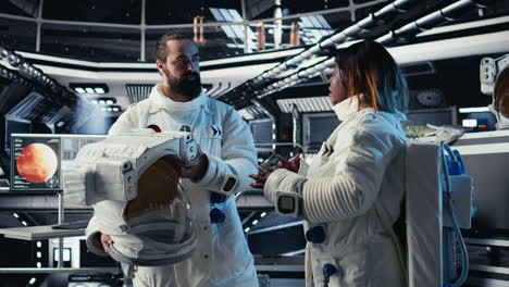 astronaut puts helmet on before leaving space station, fist bumping colleague