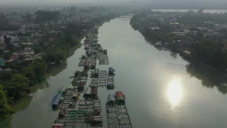 Floating-fish-farming-community-in-Bien-Hoa-on-the-Dong-Nai-river,-Vietnam-on-a-sunny-day