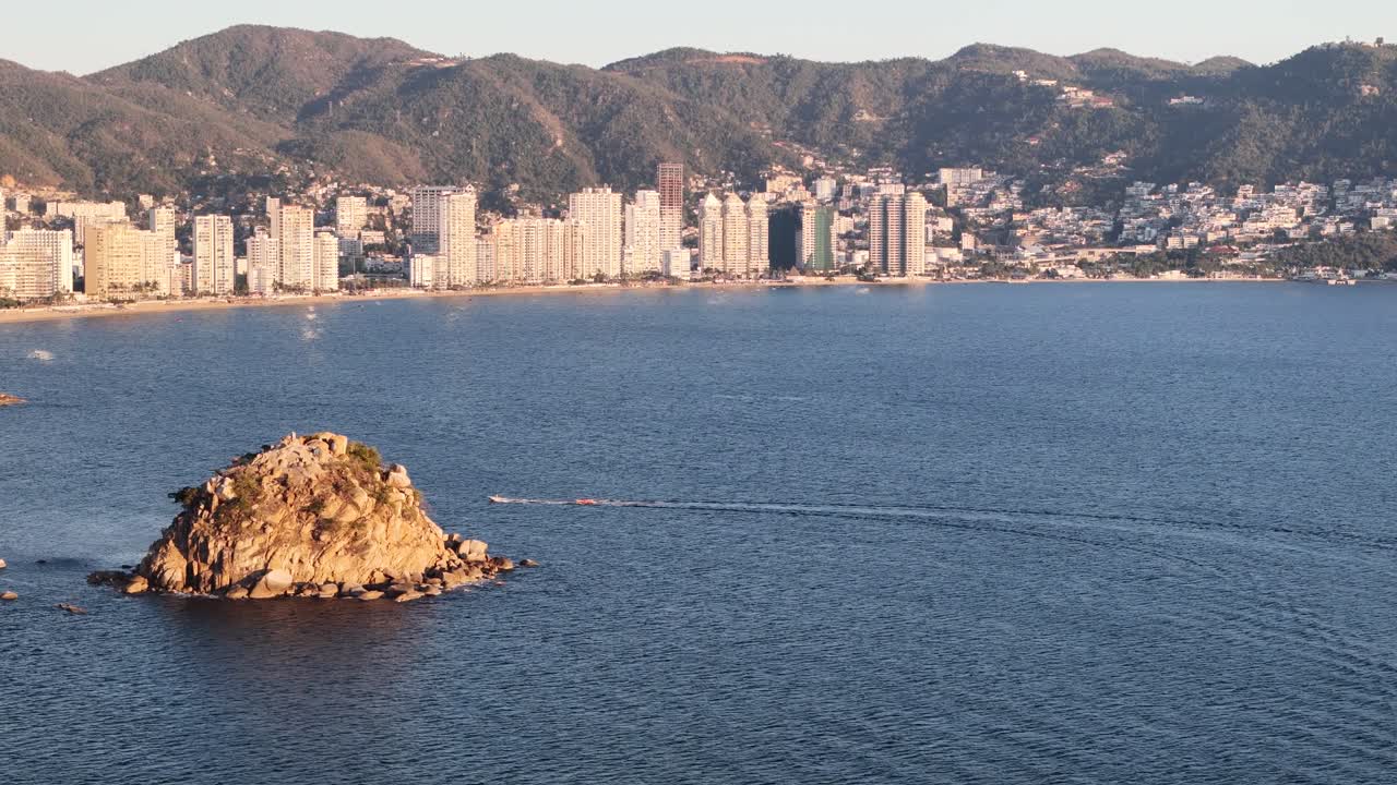 Lateral drone shot of acapulco bay