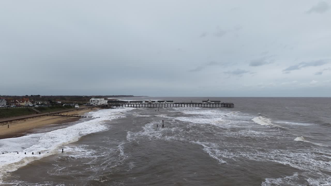 Establishing aerial shot Southwold Pier in winter rough seas Suffolk UK