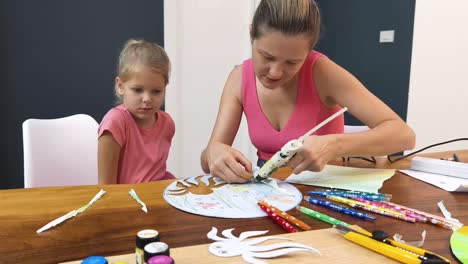 mother and daughter making an ocean themed craft