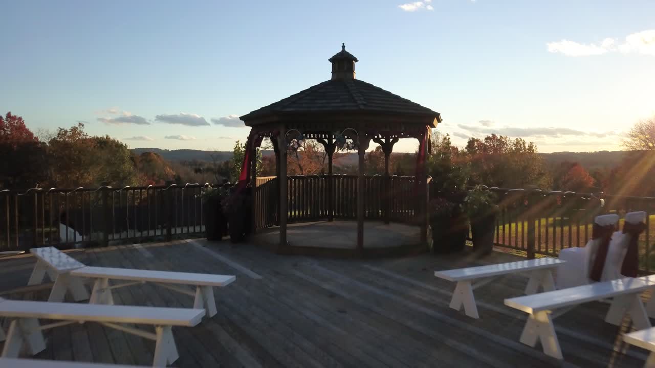 Flying over romantic gazebo and revealing majestic landscape